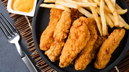 Crispy chicken tenders with fries and dipping sauce