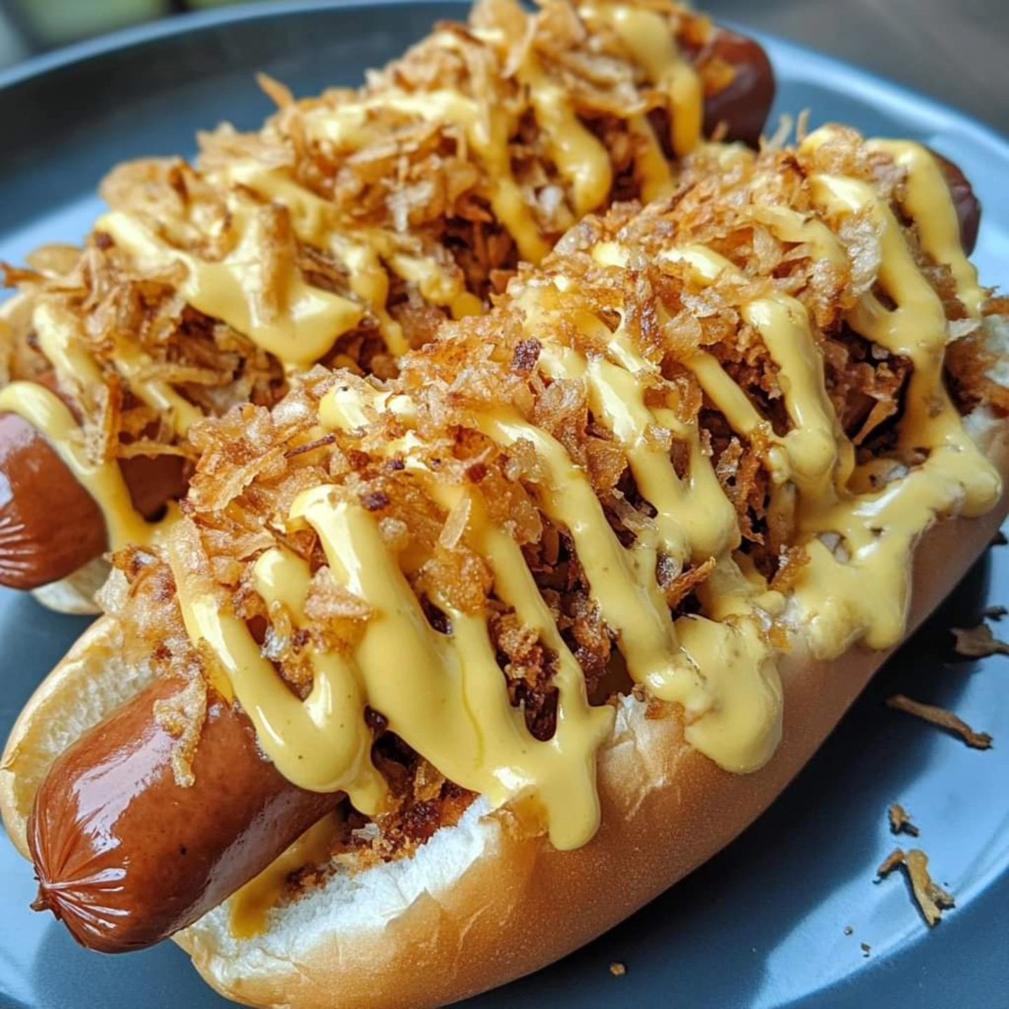 Juan hot dog loaded with crispy onions and house sauce